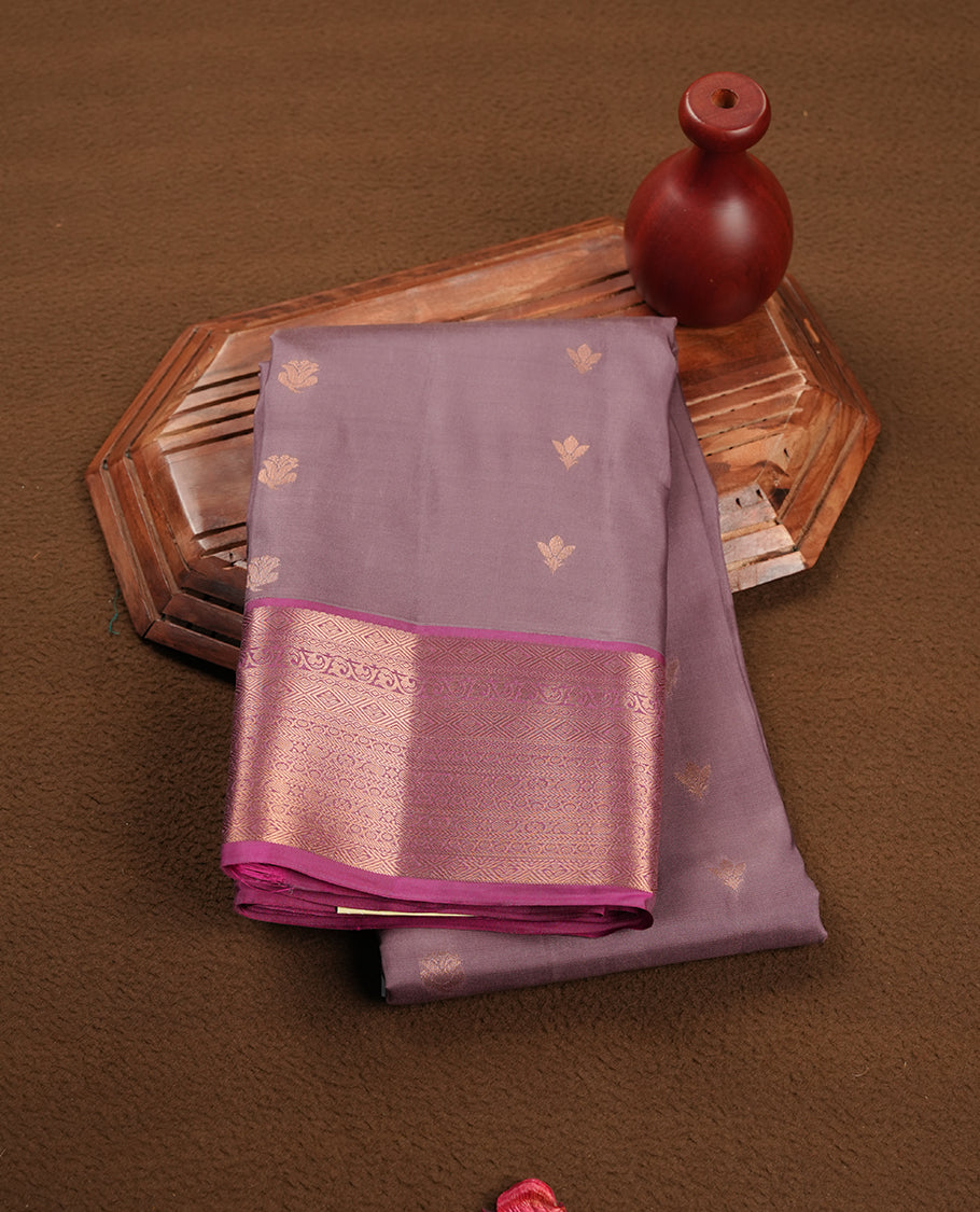 French lilac colour soft silk saree featuring gold zari motifs on the body, complemented by a contrast Magenta traditional zari border and pallu, paired with matching blouse piece.