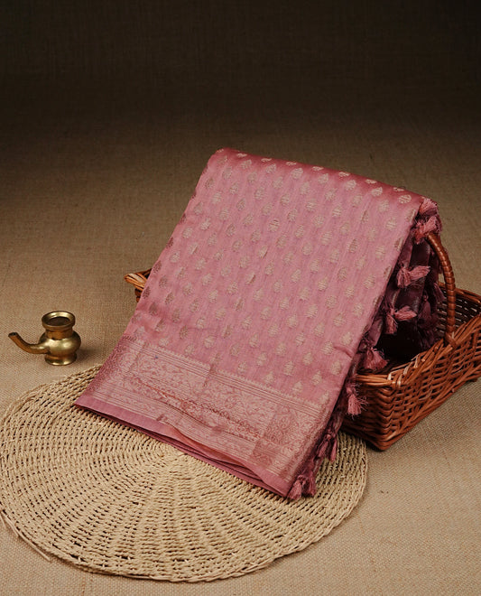 Dusty Pink Colour Tussar Silk saree with antique zari butta motifs On body, a self-toned floral zari border, a rich zari pallu, and Paired With a matching blouse piece.