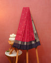 Red colour soft silk saree featuring gold zari buttas on body, contrast deep purple colour gold zari traitionl border, grand pallu comes with matching blouse piece.