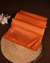 Orange colour softie silk saree featuring dotted stripes across body, complemented by self colour with traditional border, paired with matching blouse piece.