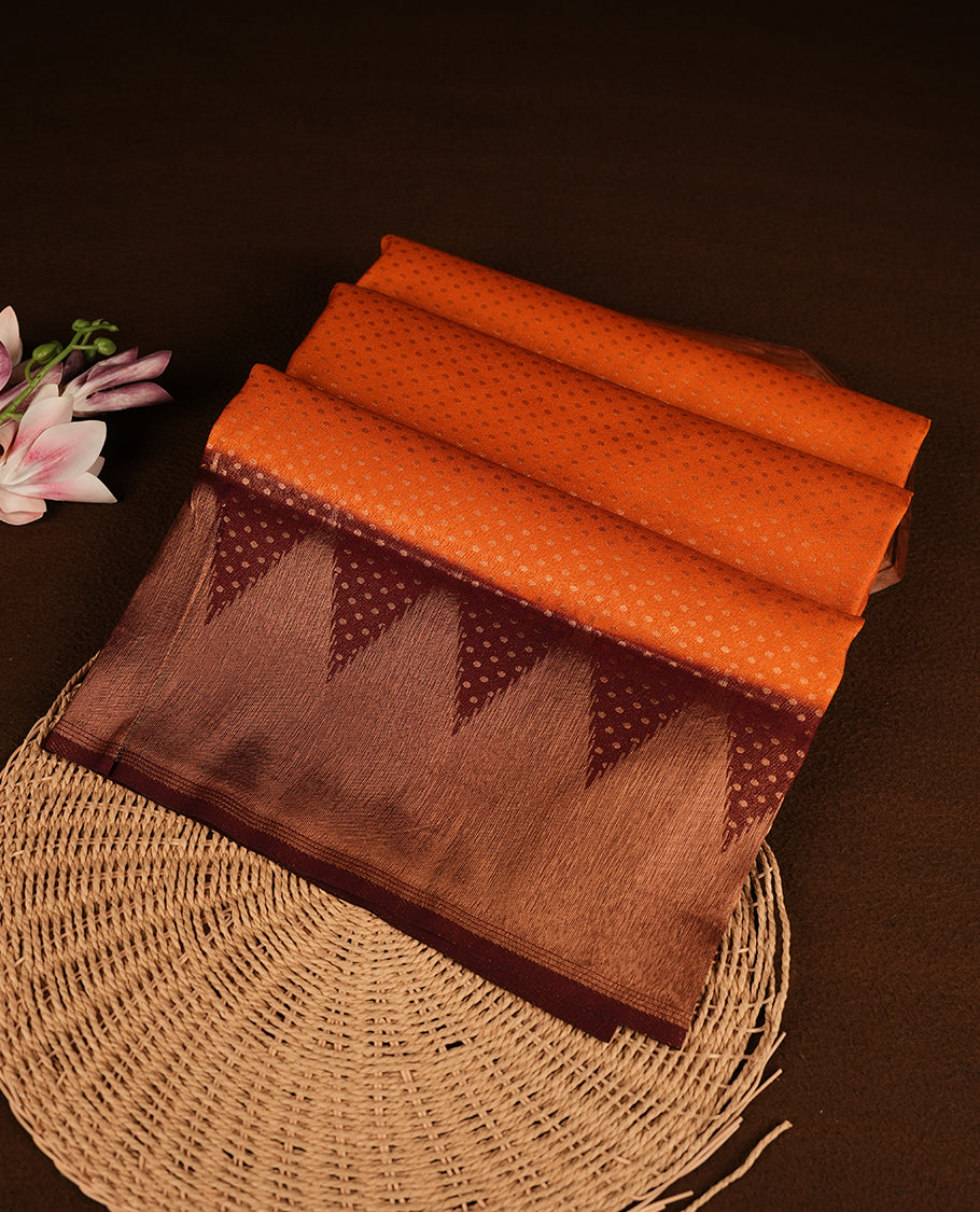 Rust orange colour softie silk saree featuring dot gold zari pattern across body, complemented by contrast chocolate brown with gold zari border, paired with matching blouse