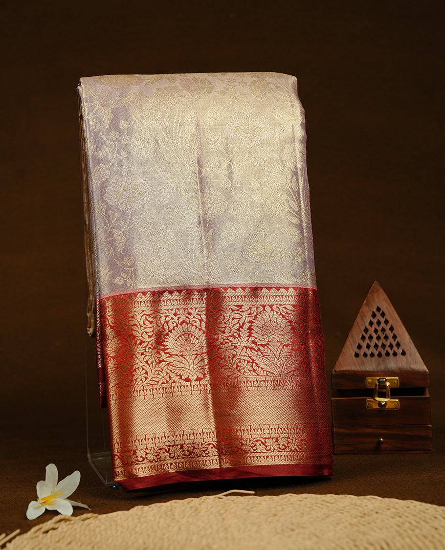 Lavender & gold double shade colour semi tissue silk saree featuring gold zari floral kodi pattern on body, contrast Maroon colour with gold zari traditional border, paired with matching blouse piece.