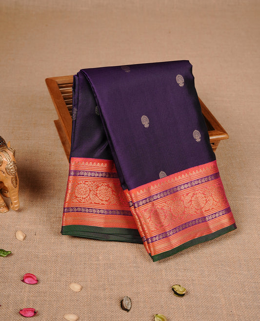 Purple colour traditional kancheepuram silk saree featuring gold zari motifs on body, complemented by contrast orange & green colour with gold zari traditional border, paired with matching blouse piece.