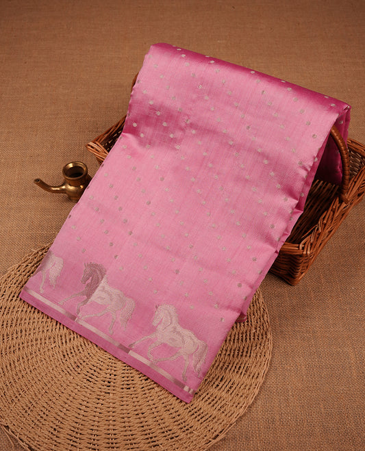 Pastal Pink colour banaras soft silk saree featuring silver zari dotted stripes on body, self colour border with silver horse pattern, pallu and paired with matching blouse.