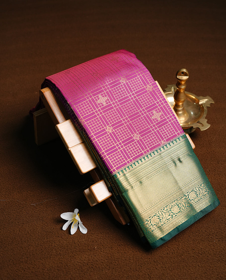 Purple colour semi wedding saree featuring gold zari motif on check pattern on body, complemented by contrast Green with traditional border, paired with matching blouse piece.