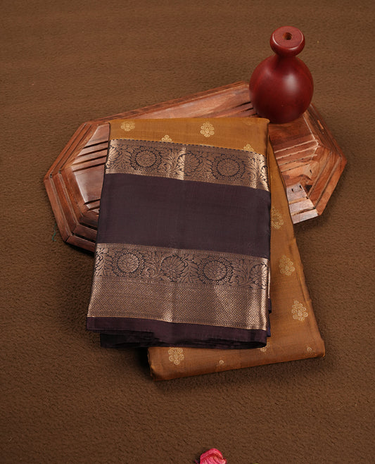 Khaki colour soft silk saree featuring gold zari motifs on the body, complemented by a contrast chocolate traditional zari border and pallu, paired with matching blouse piece.