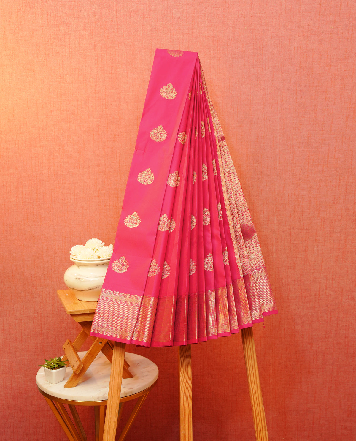 Pink colour soft silk saree featuring gold zari floral motifs on body, contrast self colour traditional border, grand pallu comes with matching blouse piece.