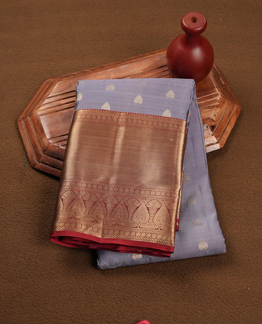Lavender colour soft silk saree featuring gold zari motifs on the body, complemented by a contrast Red traditional zari border and pallu, paired with a matching blouse piece.
