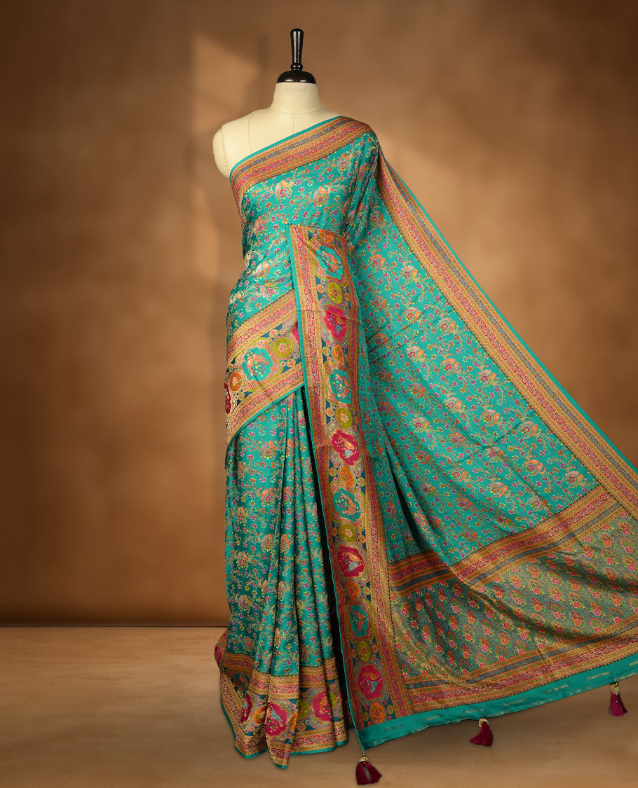 Aqua green colour Pashmina silk saree densely woven with intricate multicolour floral kodi pattern across the body, framed by an opulent arabesque border and grand storytelling pallu, paired with a matching woven border blouse piece