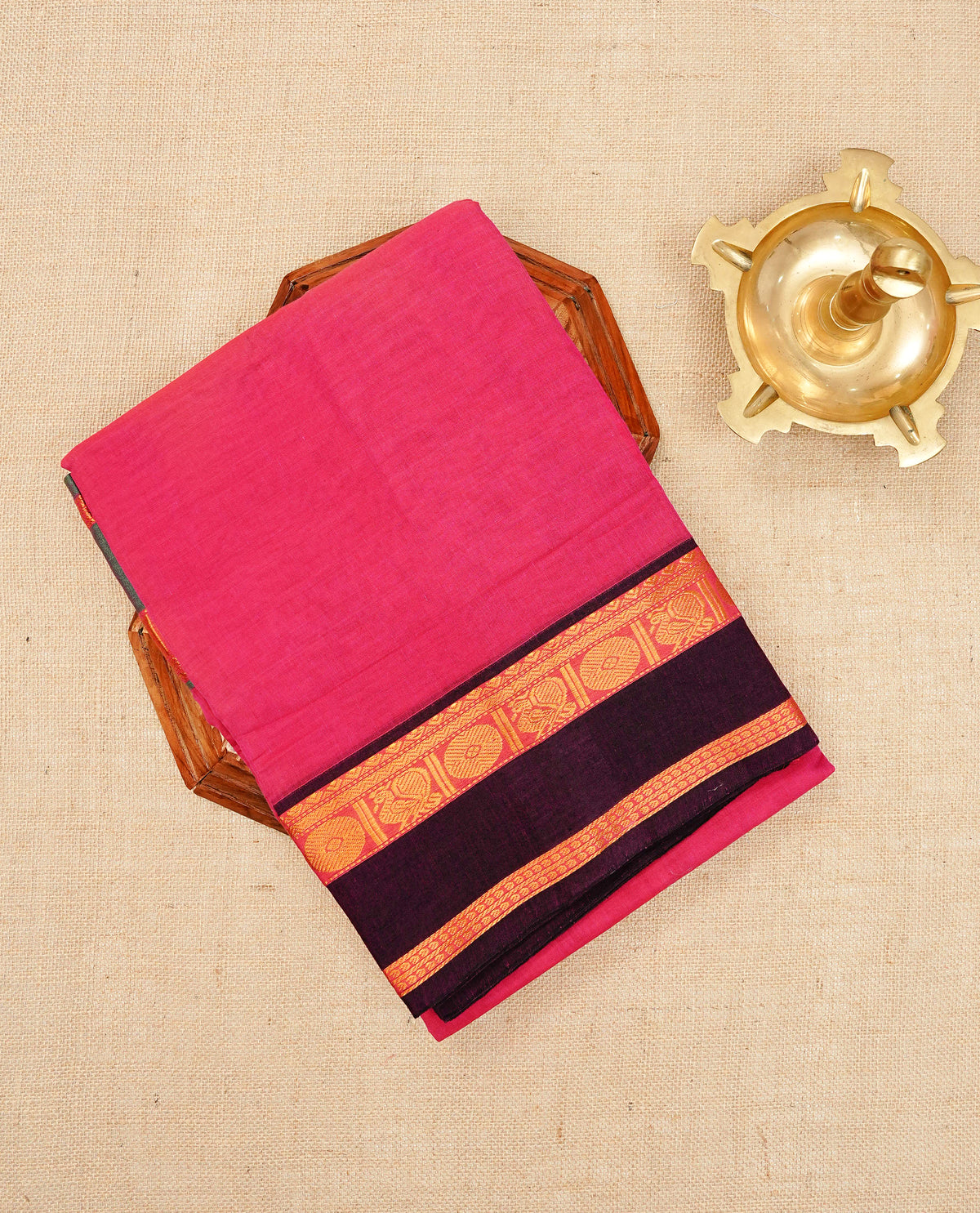 Magenta colour Narayanapattu cotton saree with a plain body, complemented by a red colour border featuring Dark brown colour with gold zari border & a contrast pallu, paired with a matching blouse piece.