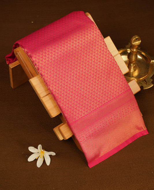 Meganta colour semi soft silk saree featuring gold zari motifs on across body, self colour border with traditional gold zari pattern, pallu and paired with matching blouse.