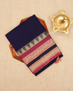 Dark Purple colour Narayanapattu cotton saree with a plain body, complemented by a magenta border featuring gold zari temple and elephant motifs & a contrast pallu, paired with a matching blouse piece.