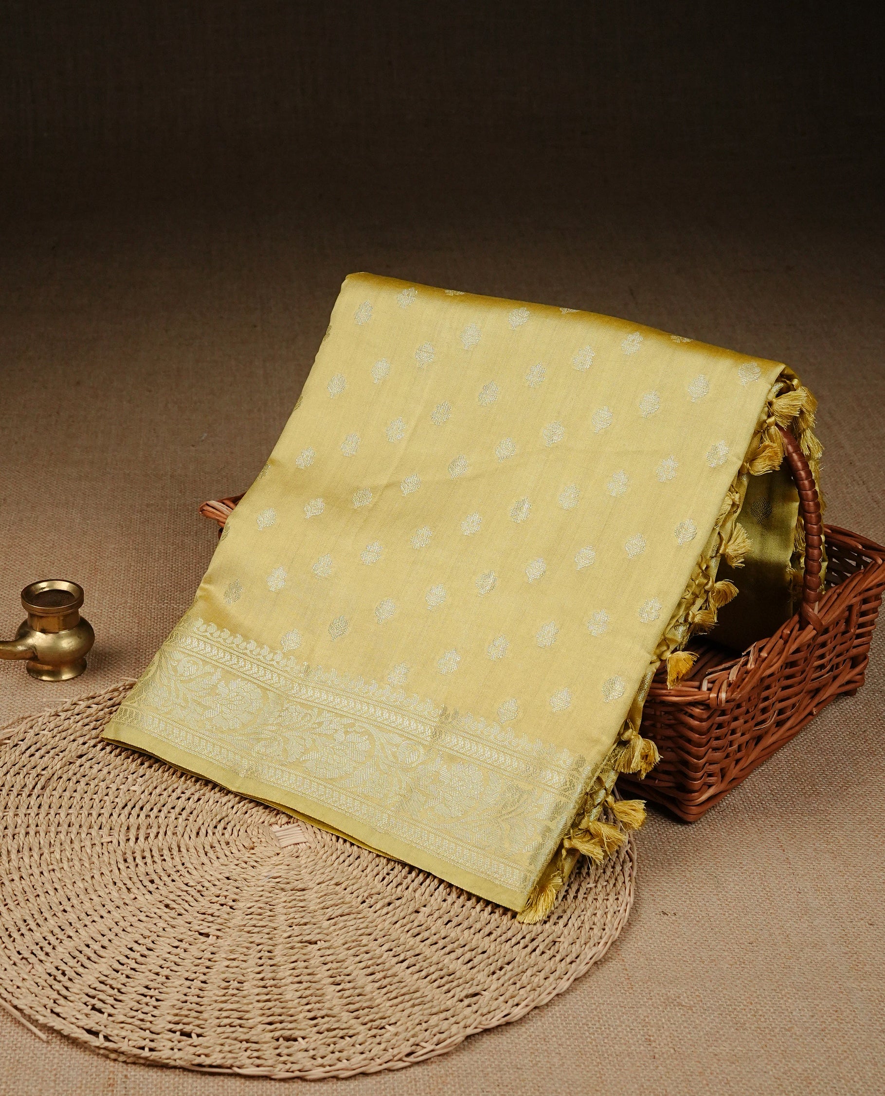 pastel yellow Colour Tussar silk saree with silver zari buttas On Body, a Contrast  Self Coloured zari border and pallu, Paired With a matching blouse piece.