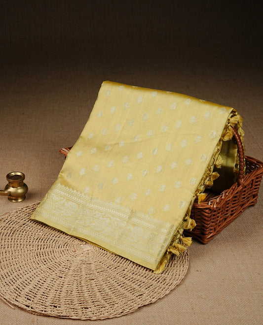 pastel yellow Colour Tussar silk saree with silver zari buttas On Body, a Contrast  Self Coloured zari border and pallu, Paired With a matching blouse piece.