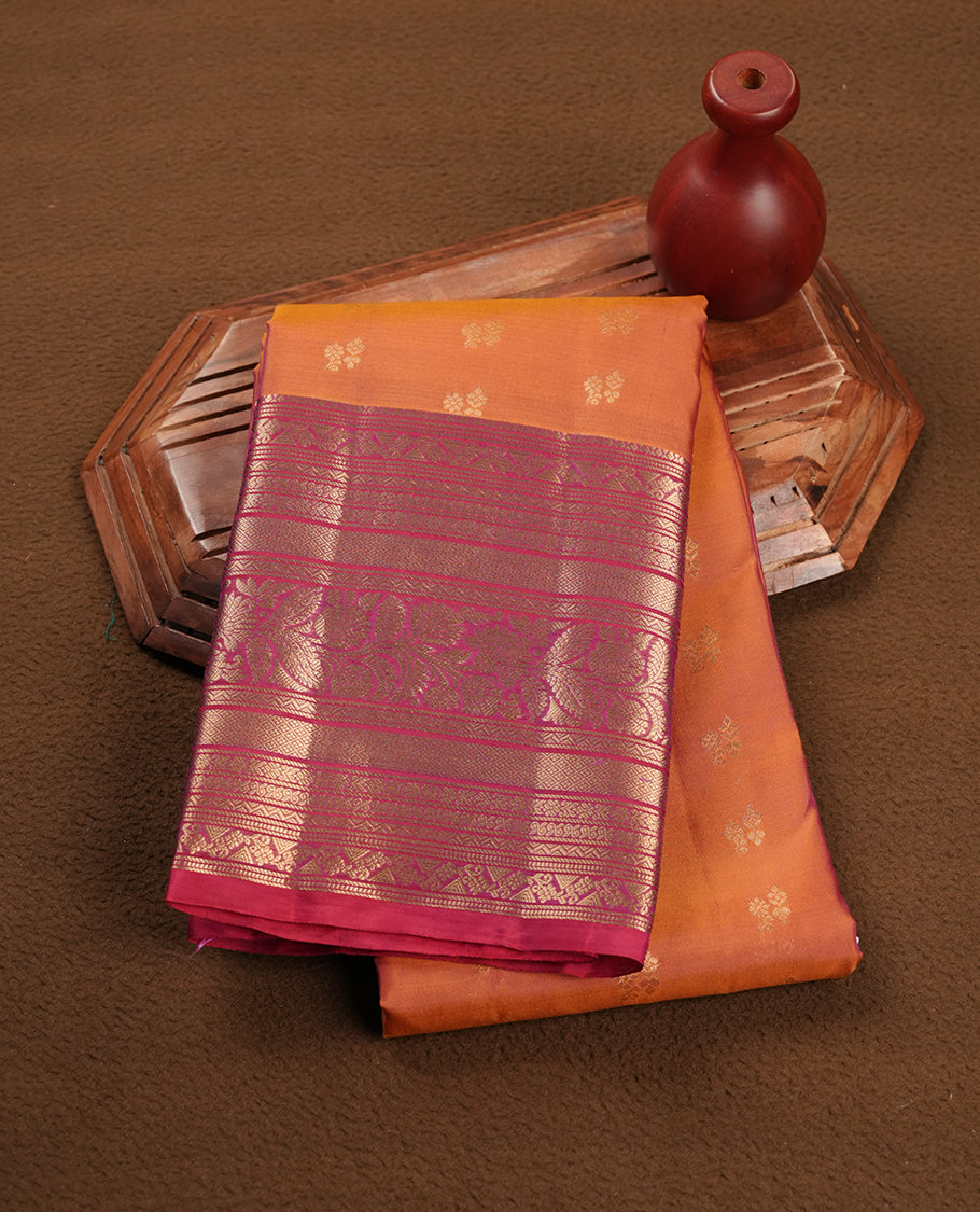 Rust orange colour soft silk saree featuring gold zari motifs on the body, complemented by a contrast Red traditional zari floral kodi border and pallu, paired with a matching blouse piece.