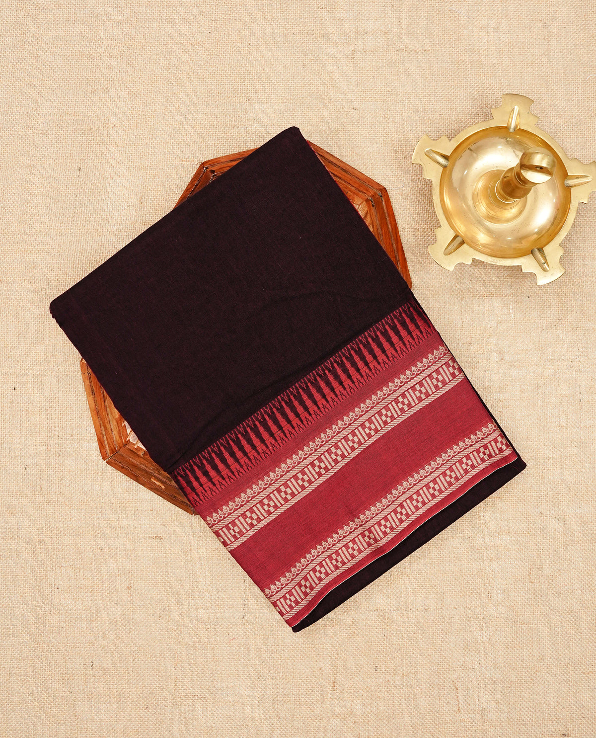 Dark Wine colour Narayanapattu cotton saree with a plain body, complemented by a Red Colour with Beige colour border & contrast pallu, paired with a matching blouse piece.
