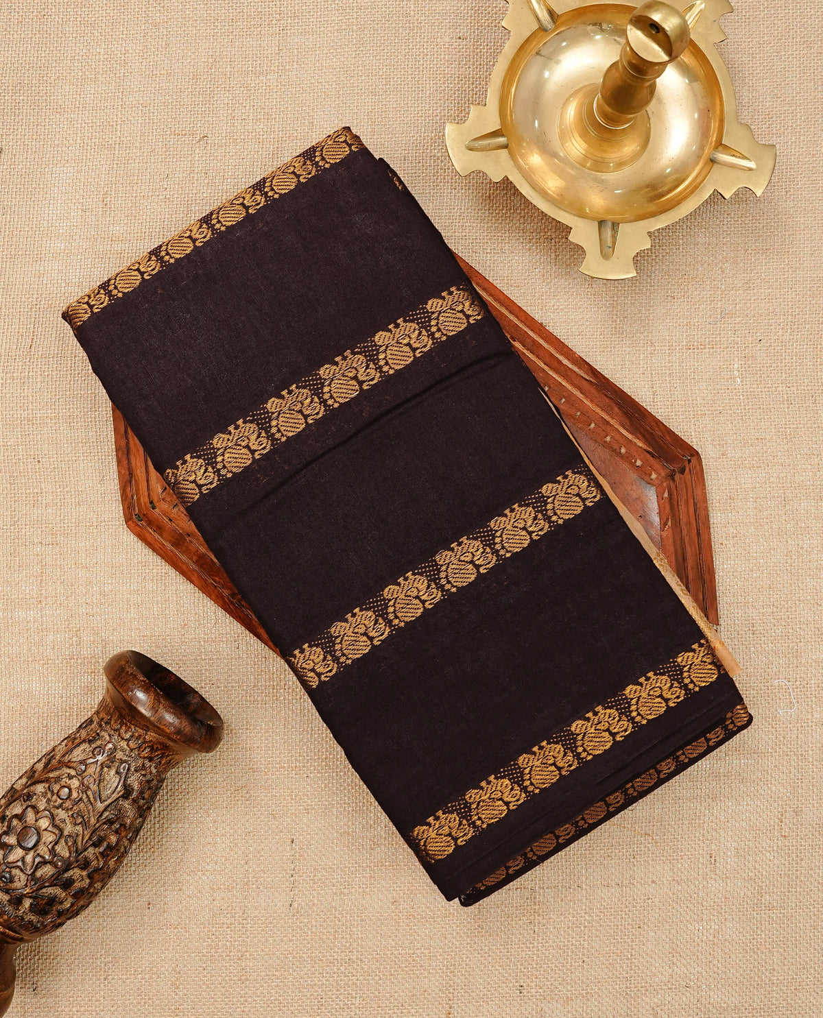 Dark chocolate Brown  Colour Sungudi Cotton Saree with peacock gold zari stripes on the body, a matching gold zari border, and a striped gold zari pallu. Paired with a contrast Beige blouse piece  featuring gold zari work.