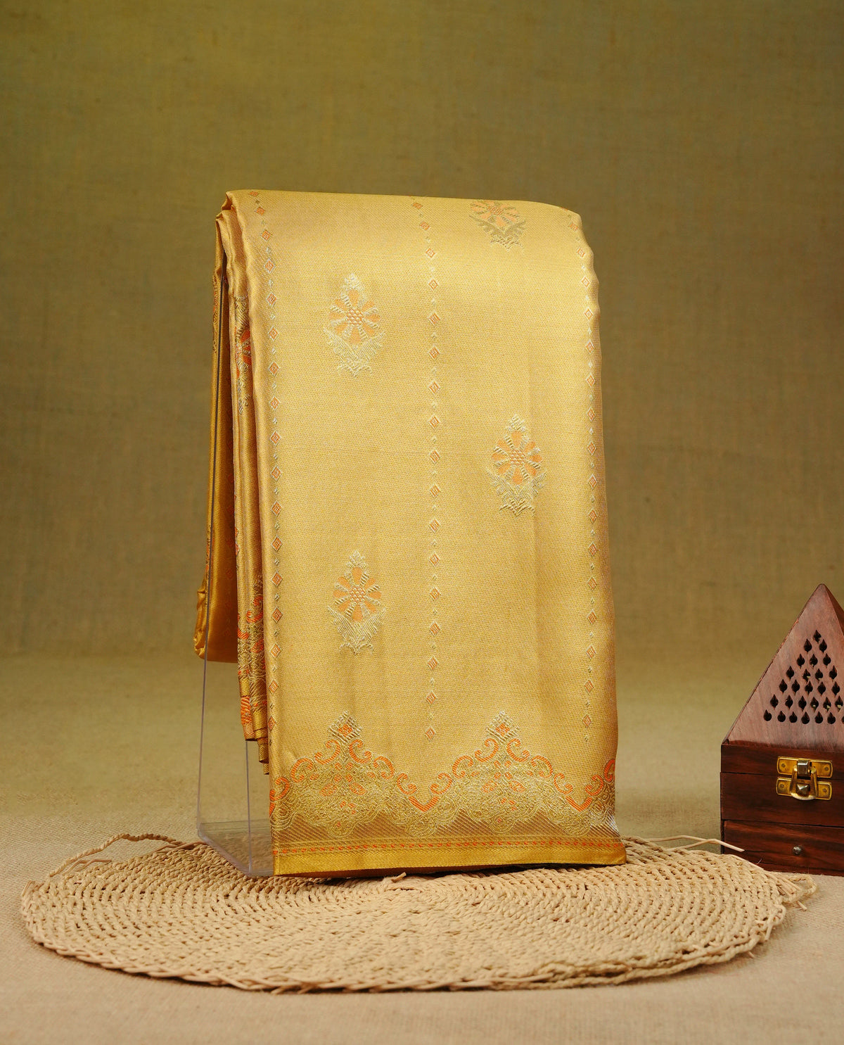 Gold colour pure tissue silk saree featuring orange doted stripes & motifs on body, complemented by self colour with simple border, comes with matching blouse piece.