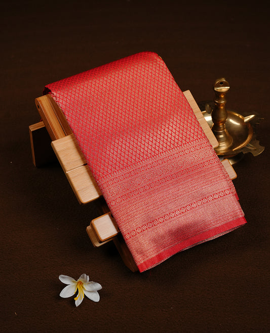 Red colour soft silk saree featuring gold zari pattern on body, complemented by self colour with traditional border, paired with matching blouse piece.
