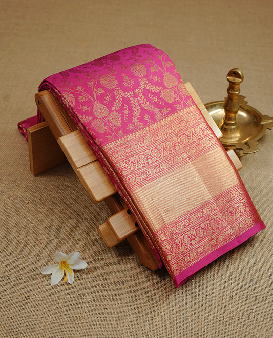 Rani pink colour kancheepuram silk saree featuring gold zari floral kodi pattern on body, complemented by self colour with traditional border, paired with matching blouse piece.