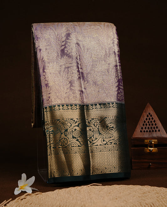 Purple & gold double shade colour semi tissue silk saree featuring gold zari floral kodi pattern on body, contrast green colour with gold zari traditional border, paired with matching blouse piece.