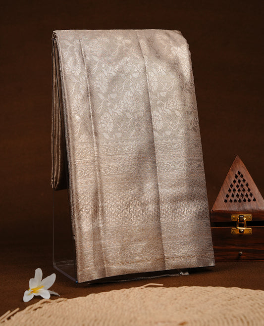 Light Gold colour semi tissue silk saree featuring gold zari pattern on body, self colour with gold zari traditional border, paired with matching blouse piece.