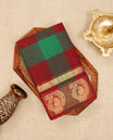 Maroon & green colour chettinad cotton saree featuring check pattern on body, complemented by Self Colour with gold zari border, comes with matching blouse piece.