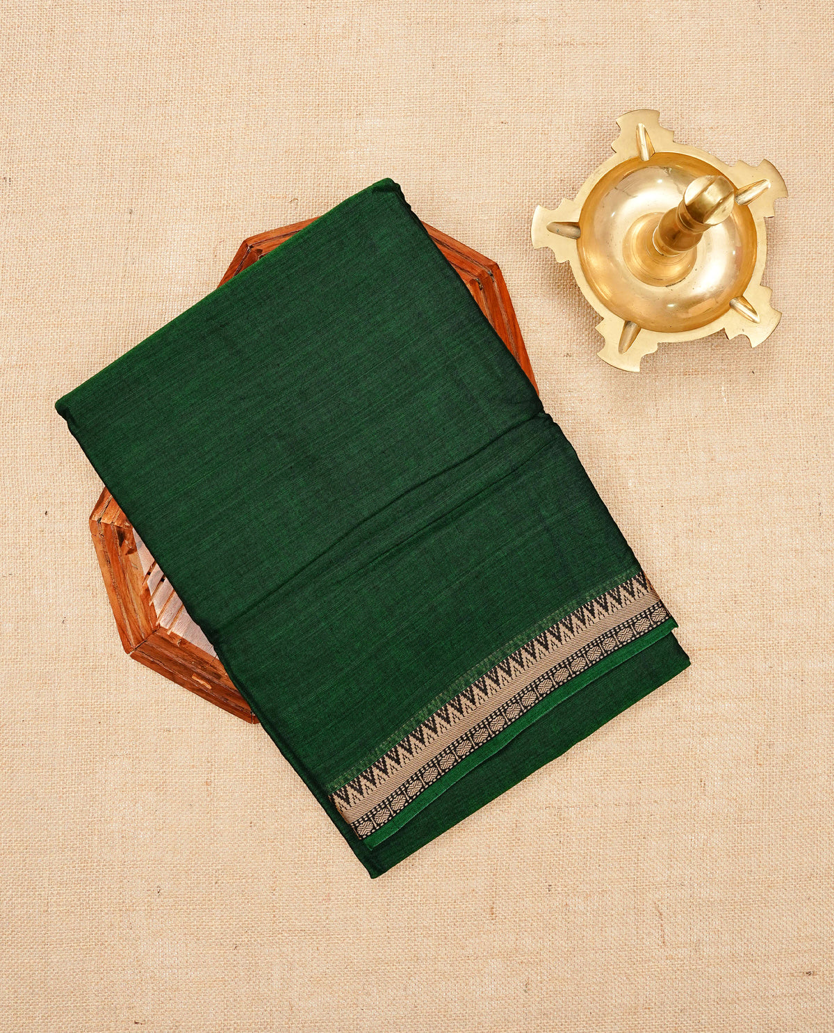 Dark green colour Narayanapattu cotton saree with a plain body, complemented by a brige Colour with Temple designed border & contrast pallu, paired with a matching blouse piece.