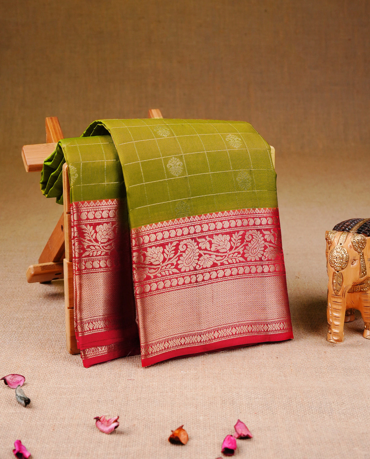 Olive green Colour Traditional Kancheepuram Silk Saree with Gold Zari Checks and Motifs on the Body, Enhanced with a Contrast Red Colour with Grand Gold Zari  Border and Rich Pallu, Paired with a Matching Blouse Piece.