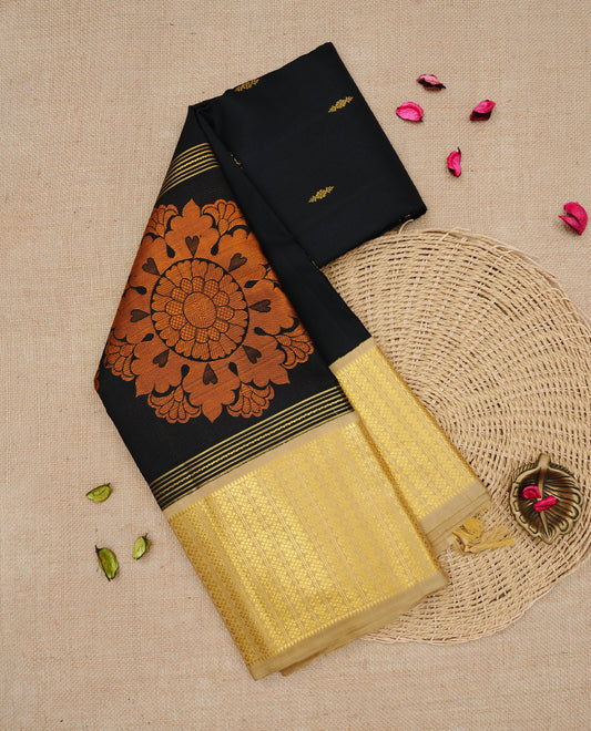 Black colour Traditional Kancheepuram silk saree featuring Gold zari Buttas, complemented by contrast beige colour with Orange zari floral pattern with traditional border, comes with matching blouse piece.