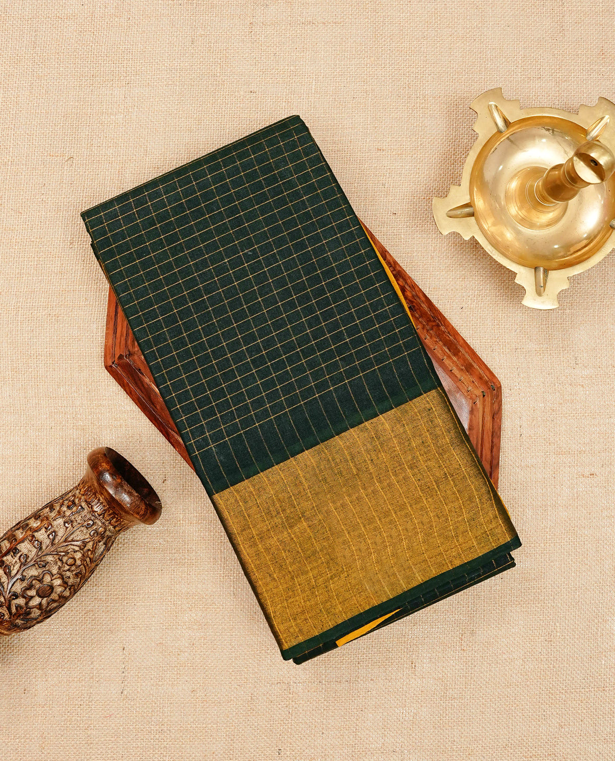 Dark green Sungudi cotton saree featuring elegant gold zari checks across the body, complemented by a contrast gold zari border. Comes with a matching blouse piece.