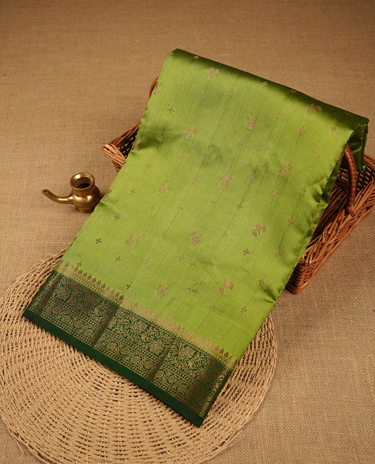 Green colour Pure banaras soft silk saree featuring Antique zari motifs on body, contrast Dark green colour border , traditional pallu and paired with matching blouse