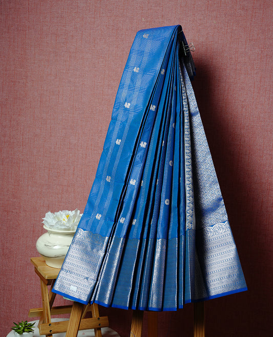 Blue coloured soft silk saree featuring Rose gold zari stripes and motifs across the body, enhanced with a Self colour with traditional border and pallu, paired with a matching blouse piece