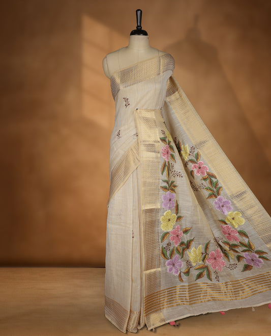 Beige colour Banarasi linen silk saree featuring hand brushed colour with Floral  & birds printed pattern on body, gold zari woven geometric design border with self colour pallu and comes with a matching blouse