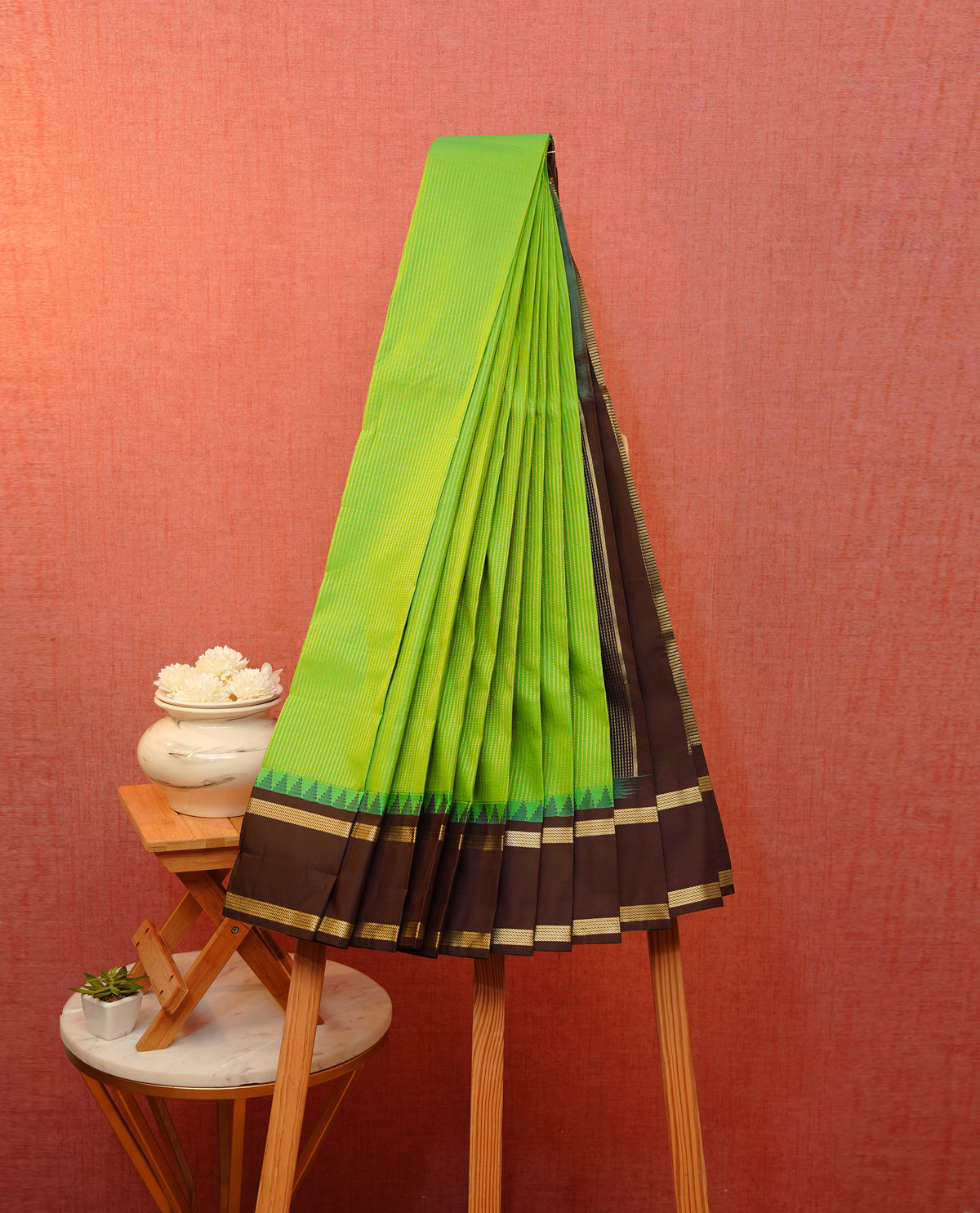 Lemon green colour soft silk saree featuring gold zari stripes on body, contrast dark maroon colour traditional border, grand pallu comes with matching blouse piece.