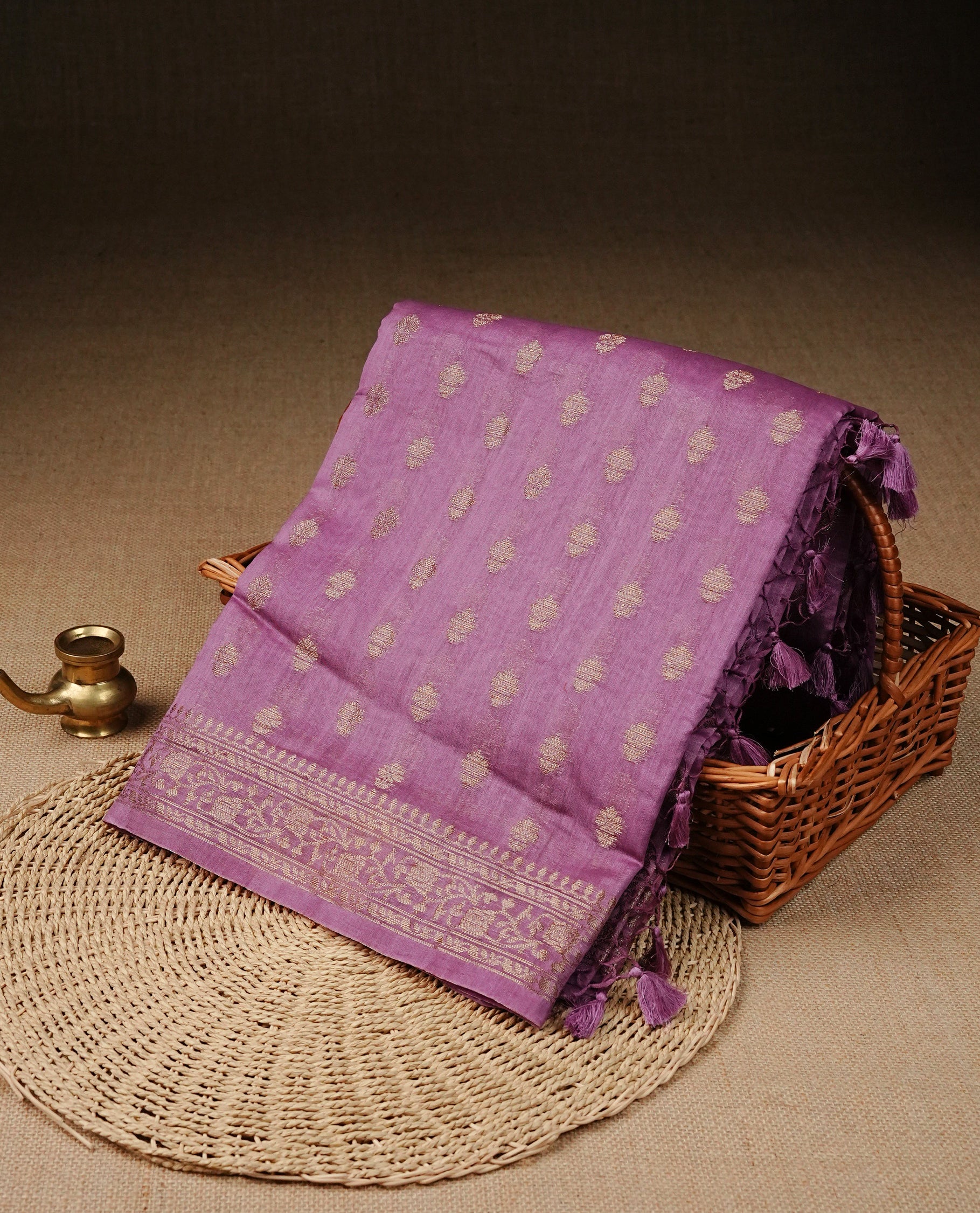 mauve  colour Tussar Silk saree featuring antique zari butta motifs on the body, enhanced with a self-coloured floral Gold zari border and  pallu, paired with a matching blouse piece.