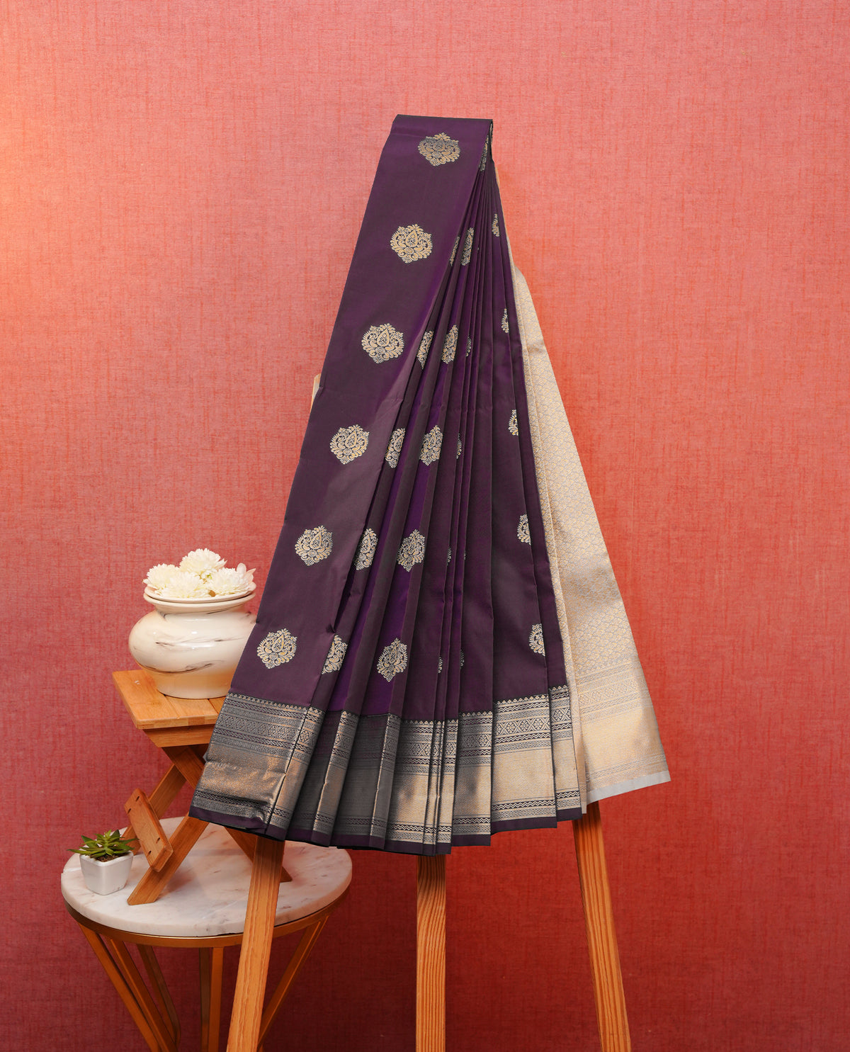 Deep purple colour soft silk saree featuring gold zari floral motifs on body, contrast self colour gold zari traditional border, grand pallu comes with matching blouse piece.
