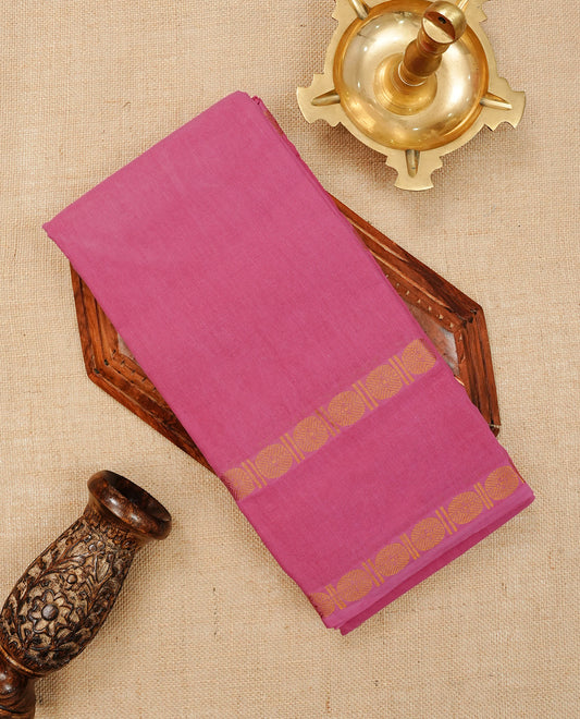 Pink  Colour  Sungudi Cotton Saree with gold zari motifs on the body, a matching gold zari border, and a plain pallu. Paired with a contrast Dark Chocolate Brown colour  blouse piece  featuring a gold zari peacock border.