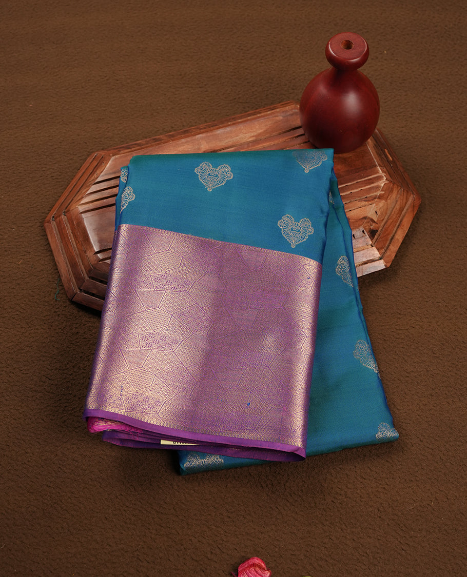 Peacock colour Soft silk saree featuring gold zari motifs on the body, complemented by a contrast indigo traditional zari border and pallu, paired with a matching blouse piece.