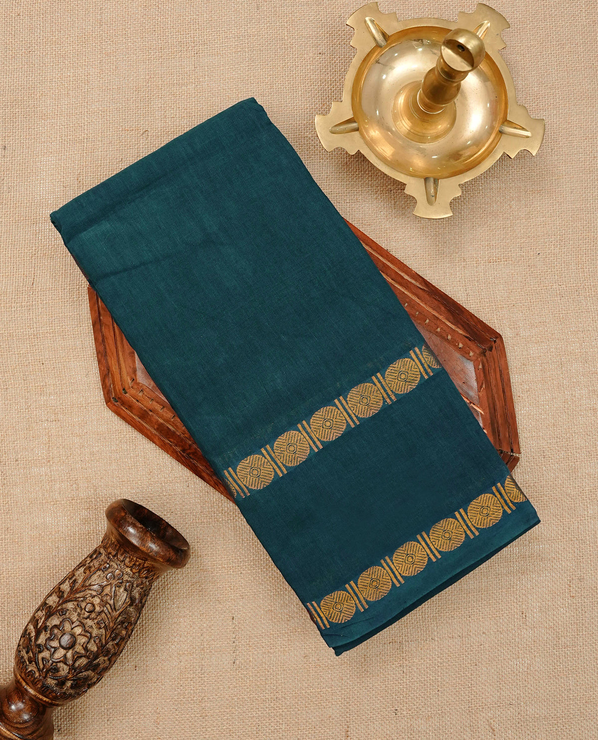 Teal Green  Colour Sungudi Cotton Saree with gold zari coin motifs on the body, a matching gold zari border, and a striped gold zari pallu. Paired with a contrast maroon blouse featuring a gold zari border.