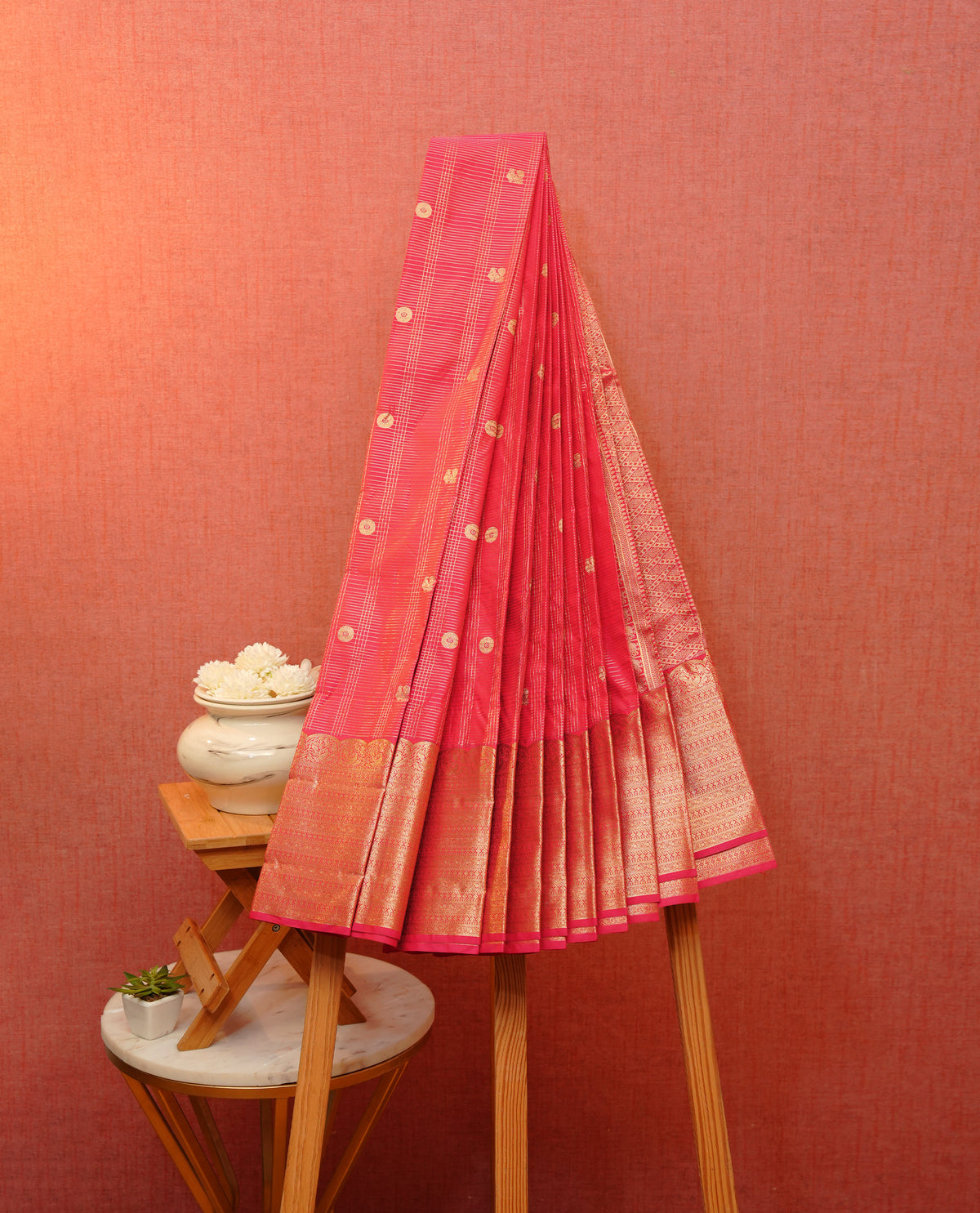 Reddishpink colour soft silk saree featuring gold zari stripes with peacock & chakra mtifs on body, contrast self colour gold zari peacock & traditional border, grand pallu comes with matching blouse piece.