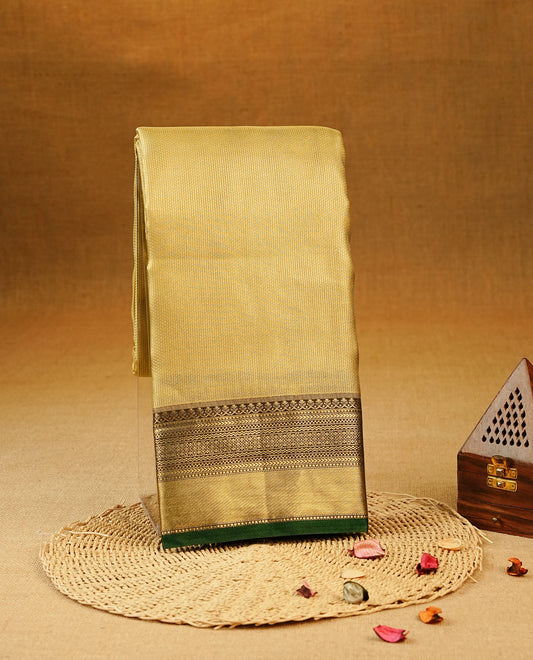 Gold Colour Semi Tissue Silk Saree featuring a lustrous self-textured body, complemented by a richly woven Green and gold zari border, an elegant geometric zari pallu and paired with a matching blouse piece.