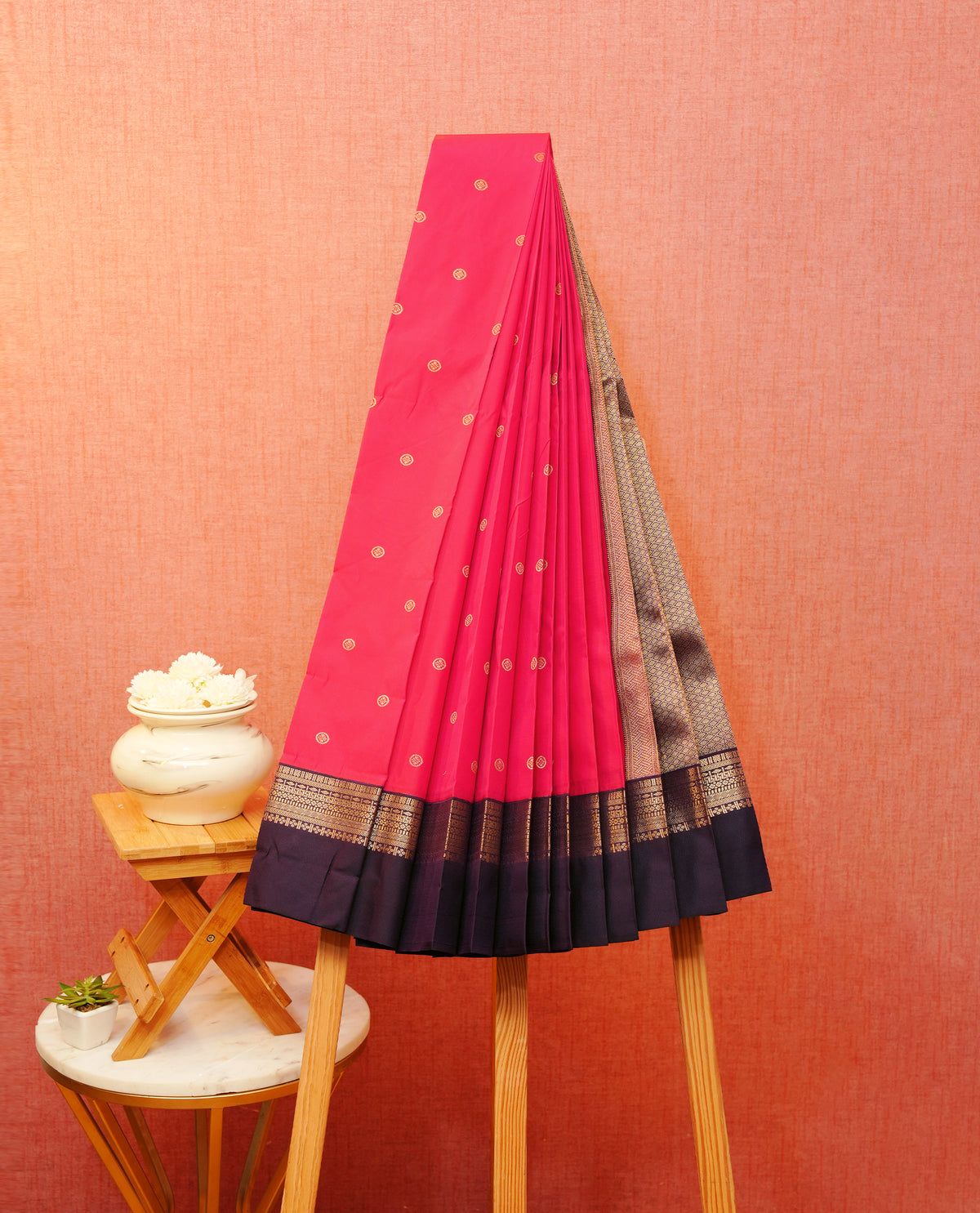 Ranipink colour soft silk saree featuring gold zari buttas on body, with contrast dark purple colour with half gold zari traditional border, with grand pallu comes with matching blouse piece.