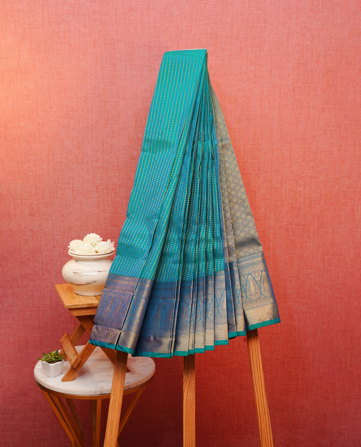 Teal blue colour soft silk saree featuring gold zari buttas on body, contrast self colour gold zari traditonal border, grand pallu comes with matching blouse piece.