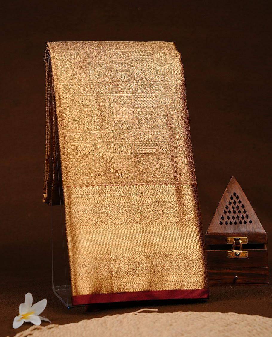 Gold colour semi tissue silk saree featuring gold zari pattern on body, contrast Maroon colour with gold zari traditional border, paired with matching blouse piece.