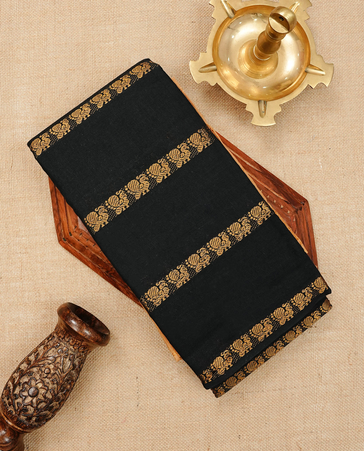 Black  Colour Sungudi Cotton Saree with peacock gold zari stripes on the body, a matching gold zari border, and a striped gold zari pallu. Paired with a contrast coffee brown blouse featuring gold zari work.