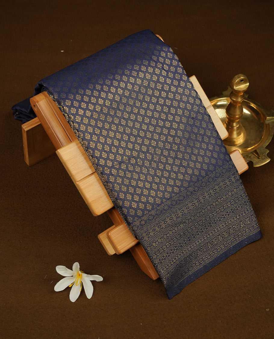 Navy blue colour semi soft silk saree featuring gold zari motifs on across body, self colour border with traditional gold zari pattern, pallu and paired with matching blouse.