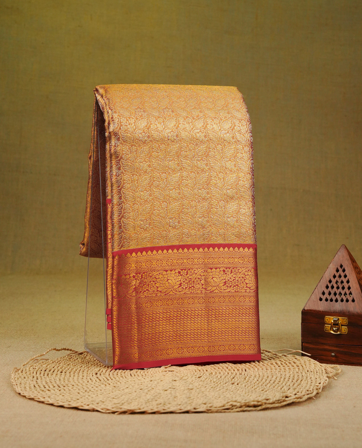 Light Red & Gold Double shade pure tissue silk saree featuring Gold Zari Leaf Patten on body, complemented by contrast Red colour Traditional border, comes with matching blouse piece.