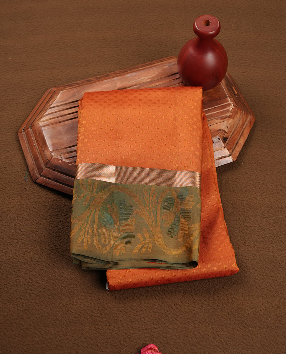 Rust orange colour soft silk saree featuring gold zari motifs on the body, complemented by a contrast Green traditional zari floral kodi border and pallu, paired with a matching blouse piece.