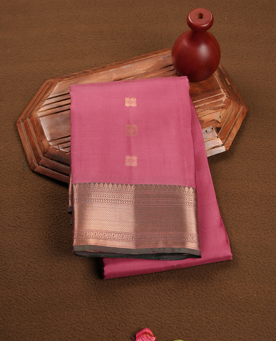 Mauve colour soft silk saree featuring gold zari motifs on the body, complemented by a contrast Green traditional zari border and pallu, paired with matching blouse piece.
